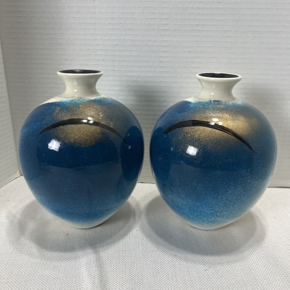 Pair of decorative blue, gold, black and Cream ceramic bottle vases